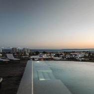 Infinity rooftop pool at sunset overlooking Alvor and the Algarve coast