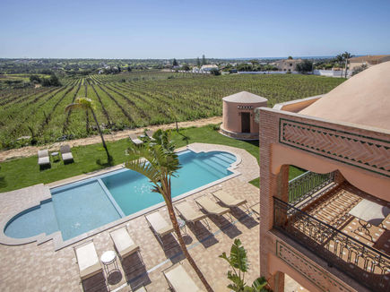 Pool, gardens and vineyards beyond at Al Karob in the Algarve