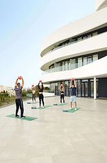 Outdoor functional training class with guests using weights on the hotel terrace