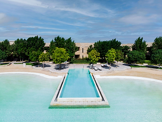 Infinity pool with lagoon and beach views at Zulal Wellness Resort in Al Ruwais, Qatar