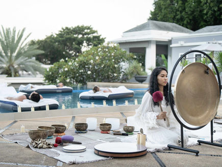 Sound healing session with guests floating on airbeds in pool at Absolute Sanctuary Thailand