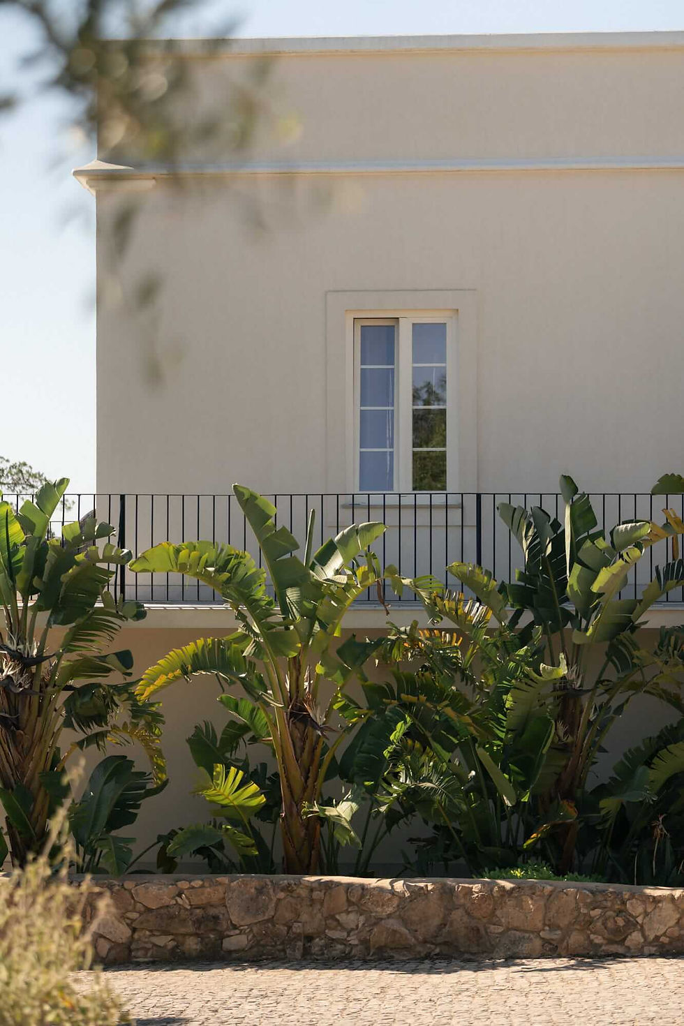Exterior of Shanti-Som Algarve, framed by subtropical planting and dry-stone walls