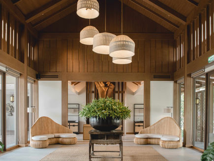Vaulted pavilion interior at RAKxa with woven lanterns and curved seating