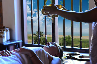 Shirodhara Ayurvedic therapy treatment with warm oil at Ayursoma Kerala.