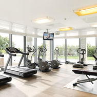 Fitness centre with treadmills, bikes, and sea-facing windows at Sun Gardens Dubrovnik wellness retreat.