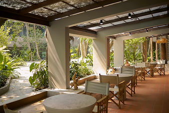 Open-air café terrace surrounded by tropical gardens at RXV Wellness Village wellness retreat in Thailand