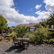 Scenic garden seating area with volcanic landscape views at Azulfit Retreat, Canary Islands