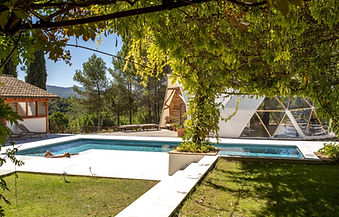 Swimming pool and wellness dome shaded by trees at MasQi Energy House Alicante