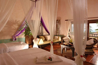 Canopy bed inside a villa at Mangosteen Ayurveda & Wellness Resort