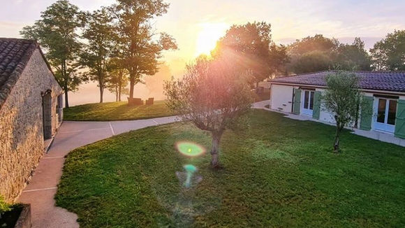 Sunrise over gardens and cottages at Maison de Lunel wellness retreat in France