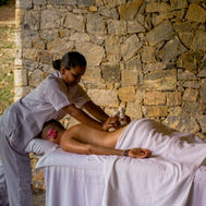 Outdoor massage treatment against a stone wall at Santani Wellness Resort
