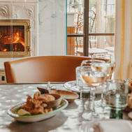 Cosy restaurant setting at Lily of the Valley Hotel with fireplace