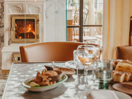 Cosy restaurant setting at Lily of the Valley Hotel with fireplace