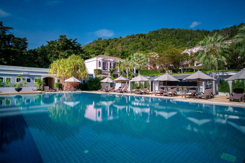 Crystal-clear blue pool and tranquil gardens ideal for stress relief at Absolute Sanctuary