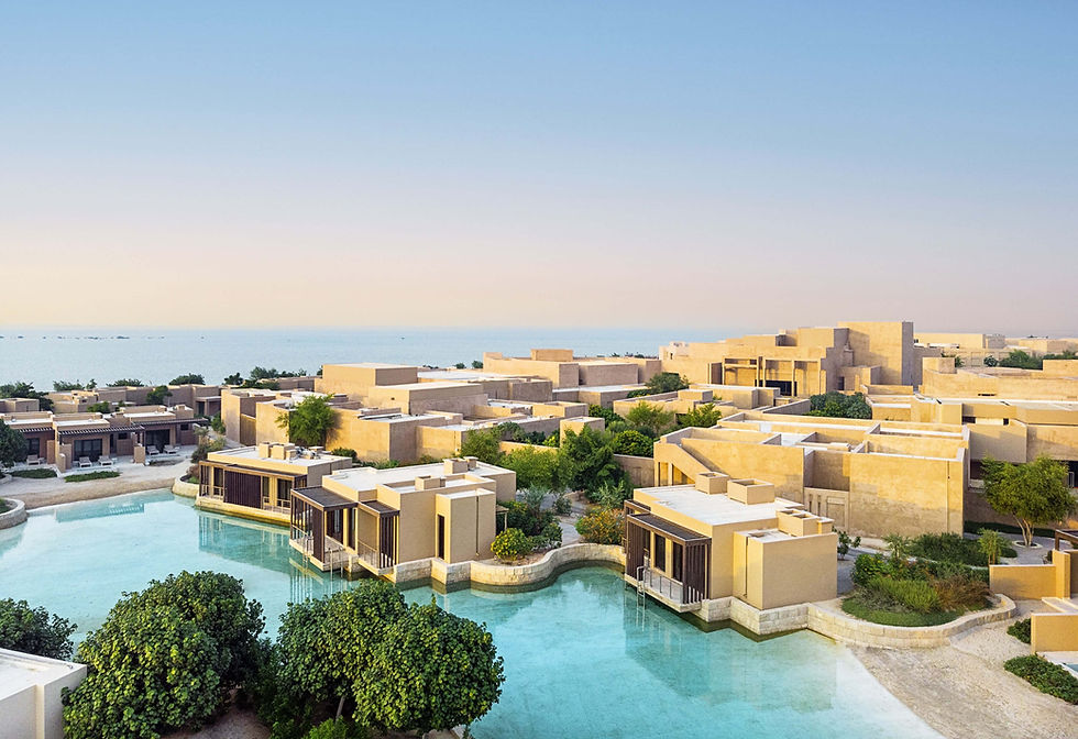 Aerial view of Zulal Wellness Resort overlooking the turquoise Arabian Gulf in Al Ruwais, Qatar