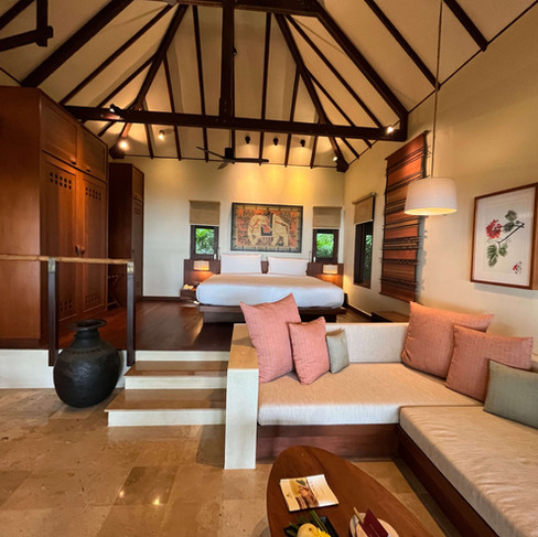 Spacious villa at Kamalaya featuring a high wooden ceiling, king-size bed, and calming earth tones