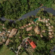 Aerial view of Fivelements Retreat Bali surrounded by lush tropical jungle and river