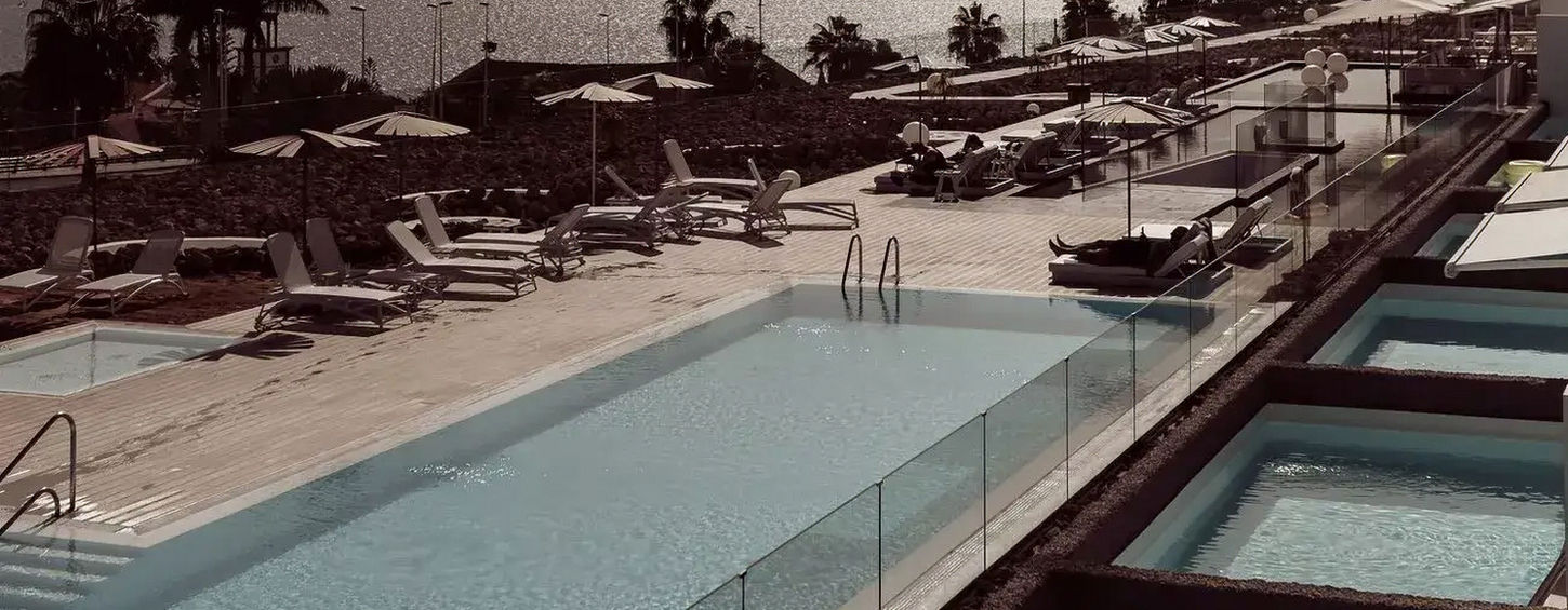 Poolside view with mountain backdrop at Baobab Suites Tenerife