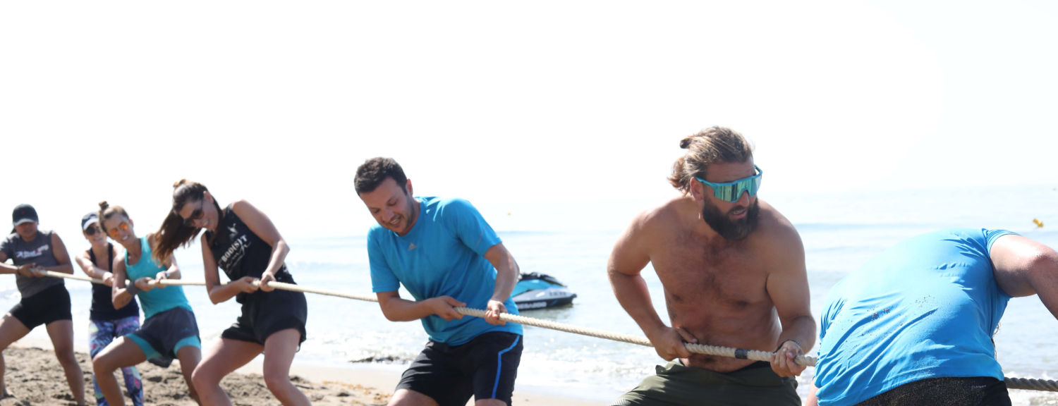 Tug of war fitness challenge on the beach at Boot Camp Marbella retreat