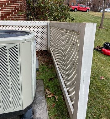 Air conditioner unit fence with wood material.