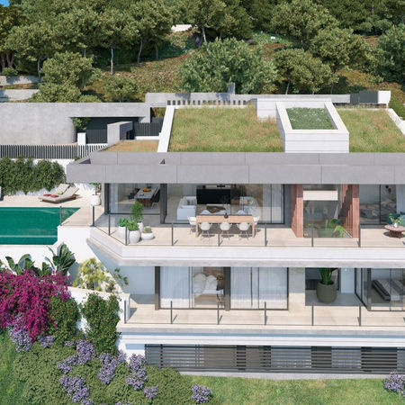 Villa Arce is the 6th property within the prestigious gated community of Pinares Hills, located in Pinares de San Antón, just north of Málaga City Centre. This modern villa boasts a total built area of 599 m², with 412 m² of covered space. The home’s floor-to-ceiling windows flood the open-plan living areas with natural light, offering magnificent panoramic views. The minimalist kitchen, which is included in the purchase price, can be customized to suit your preferences and connects seamlessly to the elegant dining area, ideal for both everyday living and hosting guests.
The villa features 5 stylish bedrooms and 4 contemporary bathrooms, each designed for comfort and aesthetic appeal. The living room, with its large sliding glass doors, leads to an expansive terrace that offers breathtaking views of the surrounding area. Outside, you’ll find a private saltwater infinity pool, extensive south-facing terraces, and beautifully landscaped gardens. Villa Arce also offers the convenience of 3 dedicated parking spaces for residents and visitors.
Located just a 7-minute drive from the famous Malagueta Beach and Málaga City Centre, Villa Arce provides a serene environment with easy access to top restaurants, shops, and cultural attractions. The high-end finishes and luxurious amenities, such as a wine cellar, entertainment room, and private office, make this home ideal for upscale living and entertaining.
Price: €3,800,000
Ref: HRB-00426P
Villa
Pinares de San Antón, Malaga - Este
5 Bedrooms
4 Bathrooms
Built Area: 599 m²
Interior Space: 412 m²
Terraces: 187 m²
Plot: 915 m²
Private Pool
Private Garden
Private Garage with 4 parking spaces
Completion Year: 2025