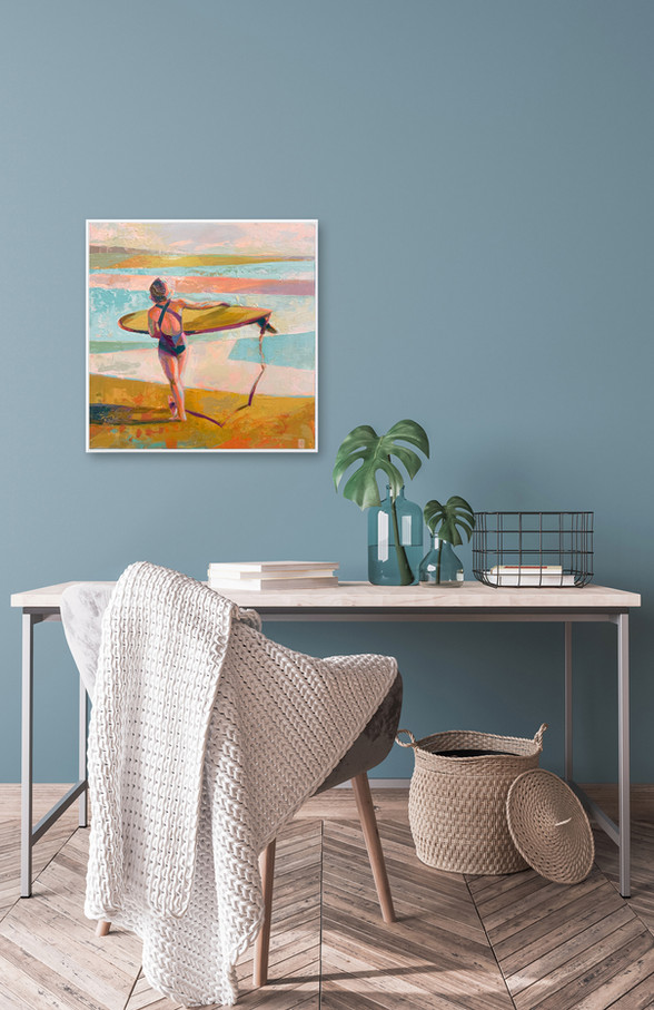 painting of a woman carrying a surf board, walking all the shore. Painting displayed in a coastal interior