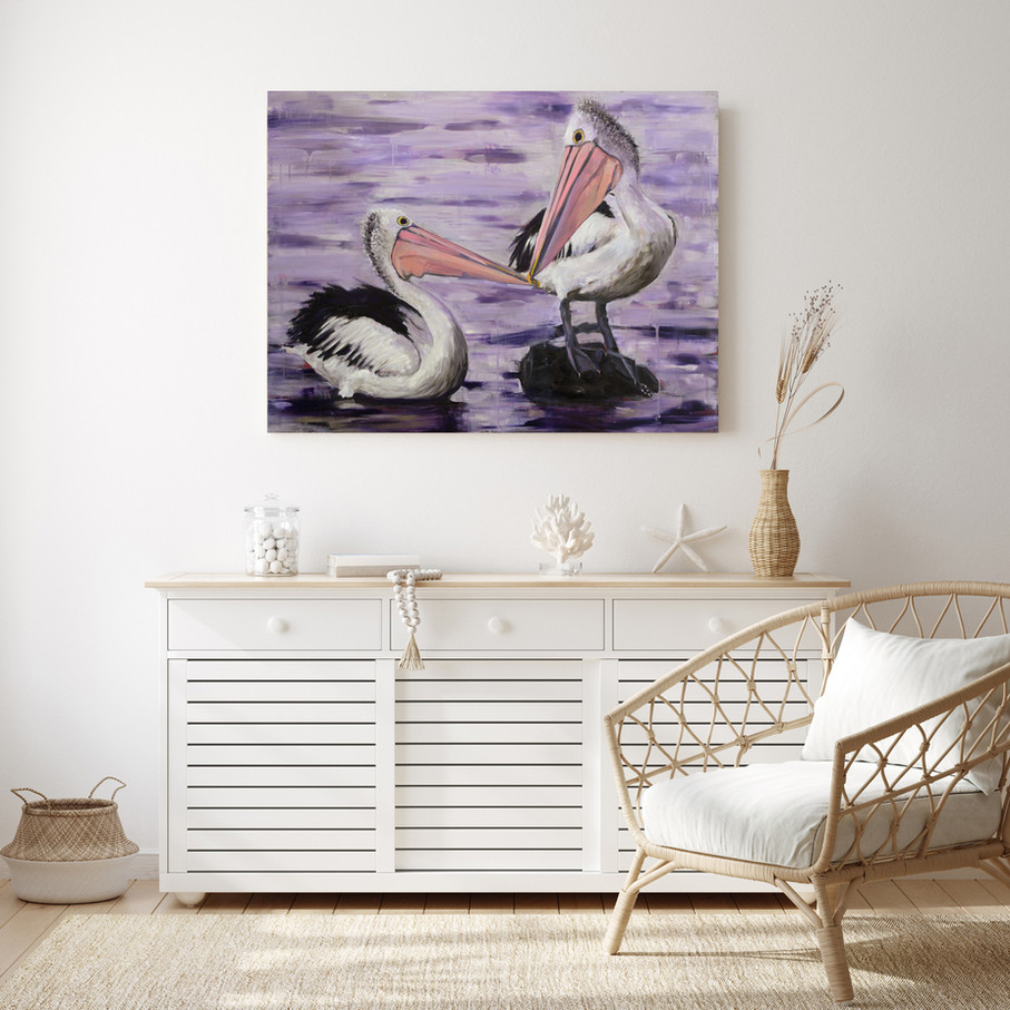 Hand-painted oil painting of two pelicans kissing in a purple sunset, displayed in living room.