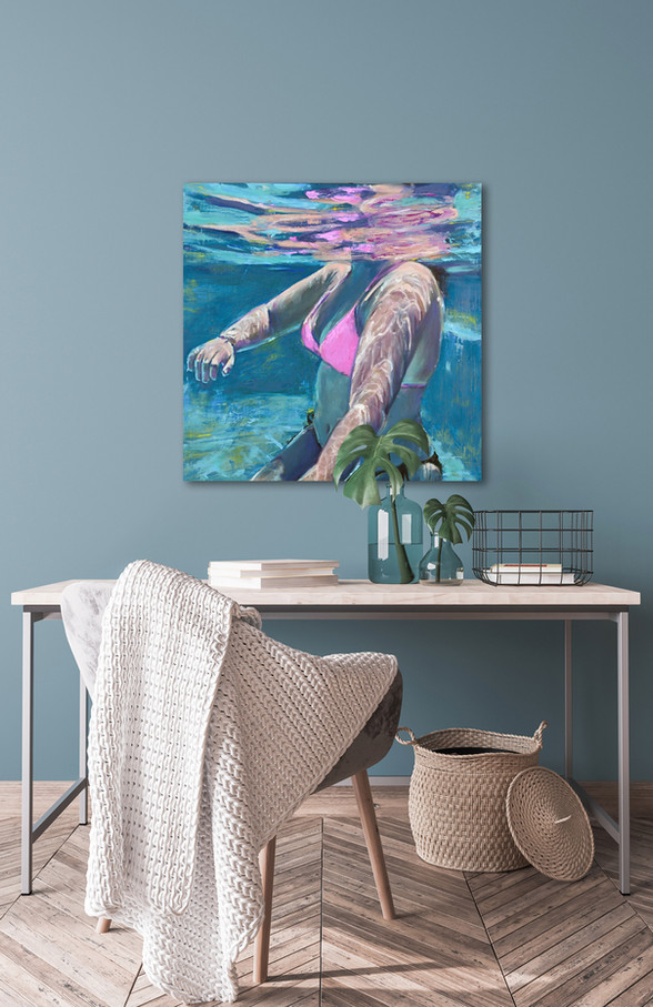Painting of a young woman underwater in a pool. Artwork is hanging in a coastal home interior