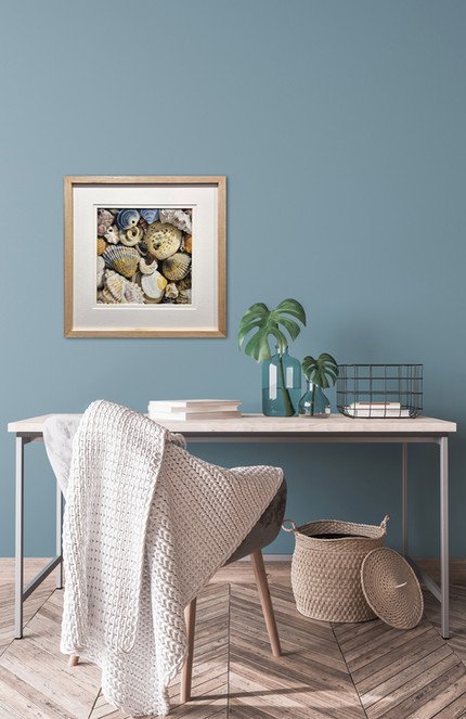 realistic pastel painting of a group of seashells, framed in oak, displayed on a blue wall