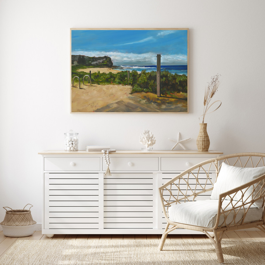 The Rinse Off limited edition print styled above a timber sideboard in a bright coastal living space.