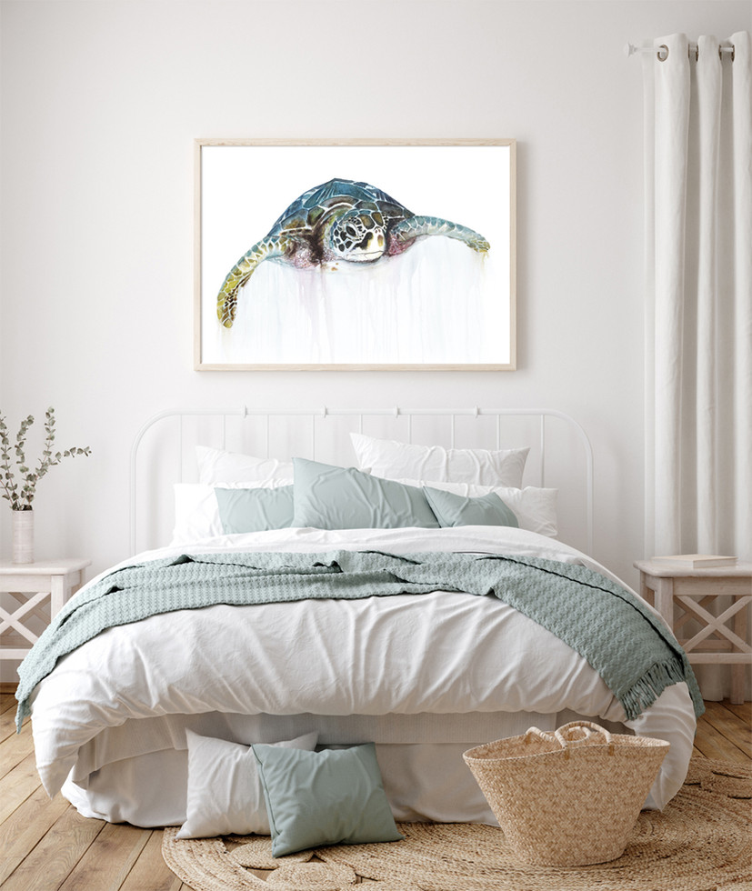 print of a sea turtle, framed and displayed above a bed