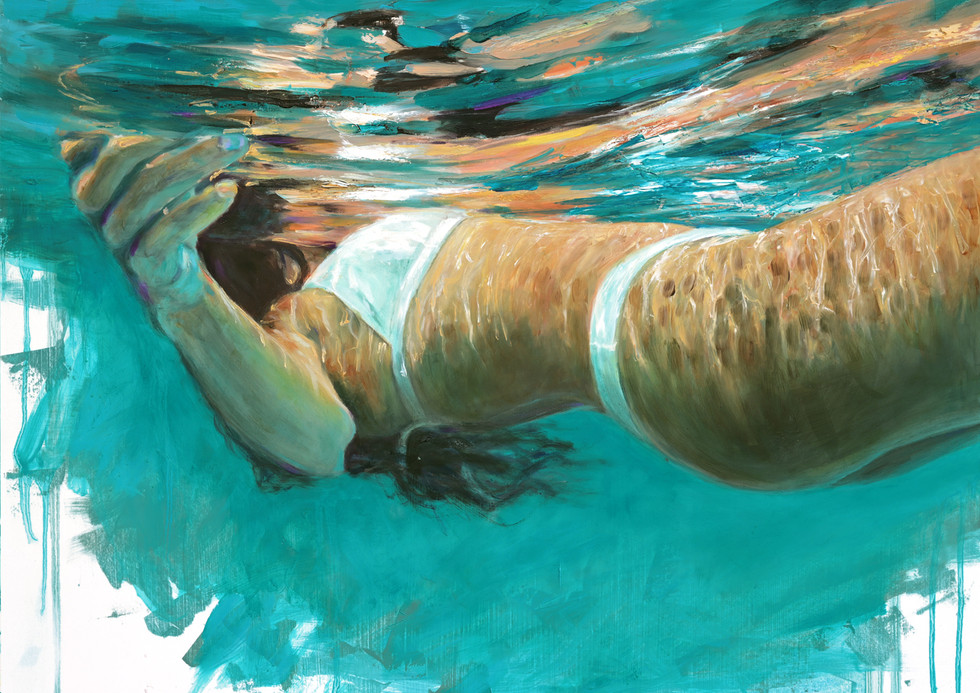 Woman submerged in blue water, wearing a white bikini top and bottoms