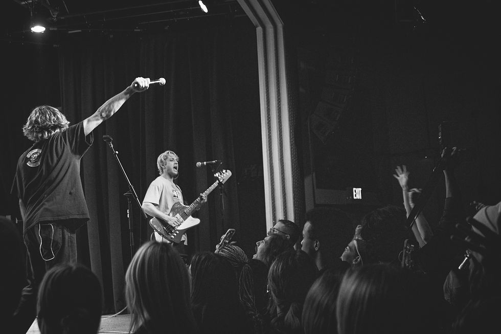 Arcy Drive performing live in concert with the crowd visible.