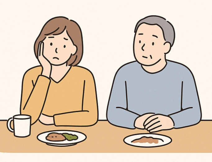 浮かない顔の妻、ぼんやり顔の夫が横に並んでいる