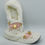 Thumbnail: White fluffy slipper with pink details and gold accents on a white