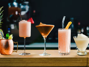 variety of frozen cocktails on a wooden bar top