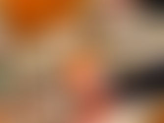 hand holding cup of frozen yogurt with toppings