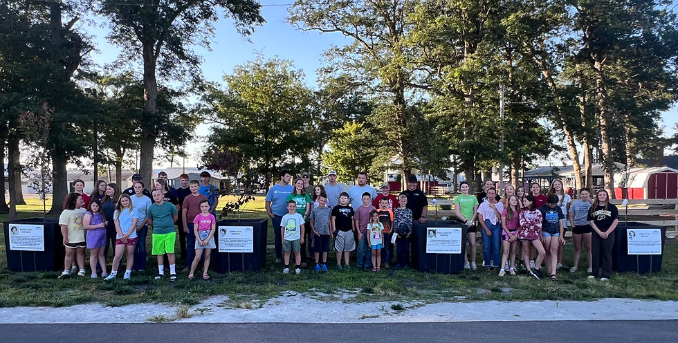Pictured is the White County 4-H Goat Club standing beside the women's memorial, at the White County Fairgrounds.