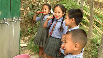 children brushing their teeth in school uniform