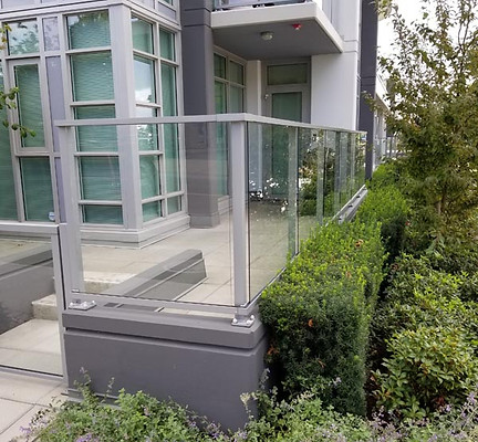 Sleek glass railings at contemporary apartment complex by AFP