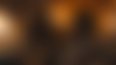 Couple sitting together by a fireplace under blankets during a cozy winter evening.