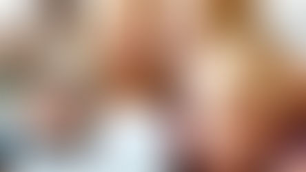 Child smiling and watching a birthday video with family while messages from friends and relatives appear on screen