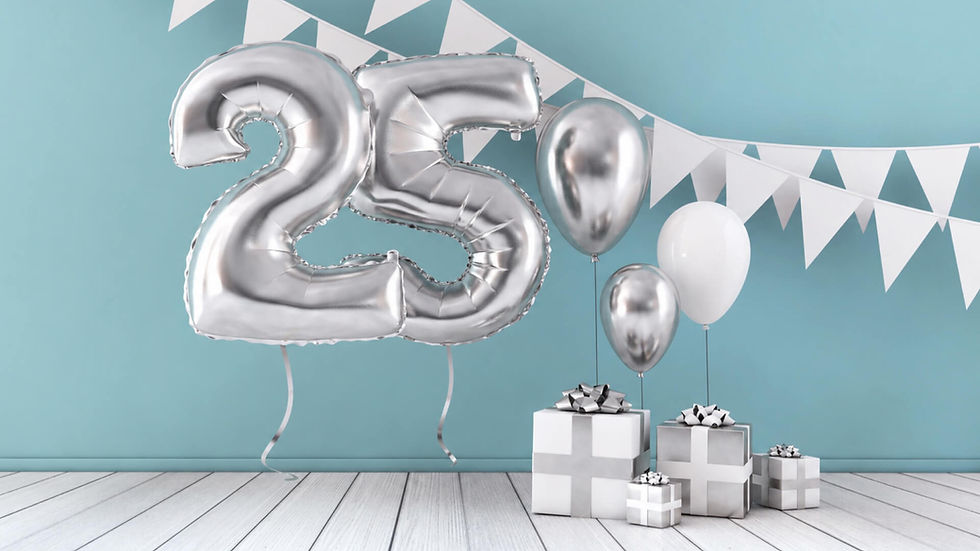 Silver number 25 balloon with white and silver balloons, wrapped gift boxes, and bunting decorations for a 25th anniversary setup.