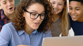 Teacher watching a video with students during a classroom appreciation moment.