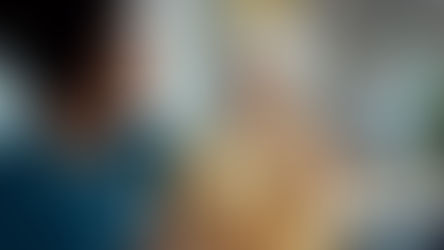 Coworkers celebrating a colleague’s retirement at an office gathering, sharing a warm moment of appreciation with drinks.