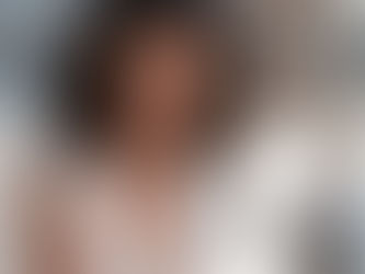 Woman smiling while recording a casual birthday video message on her phone.