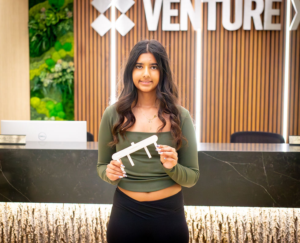 Middle and high school students presenting business ideas during a teen entrepreneurship pitch session in front of judges and parents