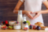 Female make shape of heart with her hands. Light summer breakfast with organic yogurts, fr