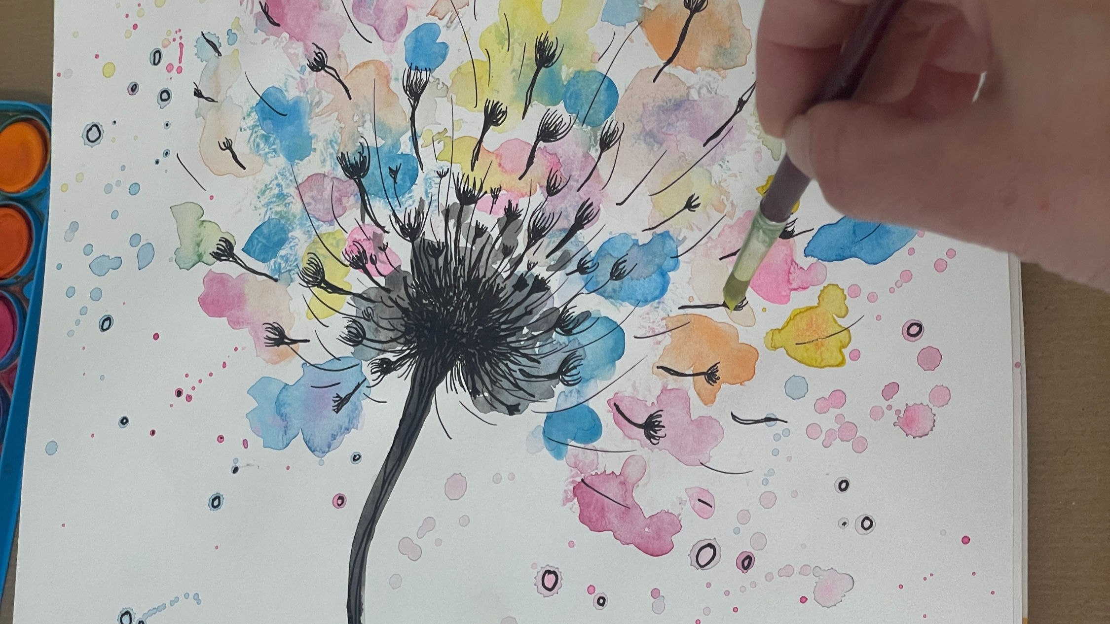 A person in a art studio  painting a soft, abstract design on a canvas.