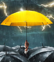 Yellow umbrella standing in a storm with lightning and rain, symbolizing protection during market volatility.